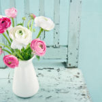 White and pink flowers in a white vase.